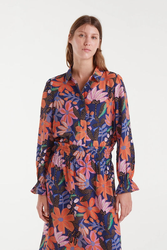 Woman wearing a colorful floral dress on a white background