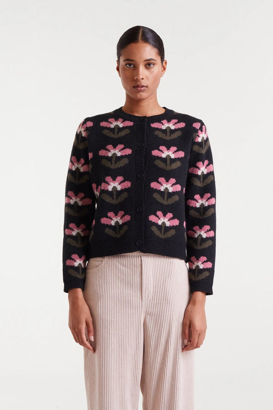 Woman wearing a black floral-patterned cardigan on a white background