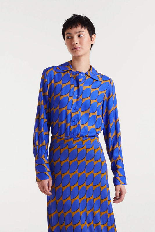 Person wearing a blue and orange patterned dress on a white background