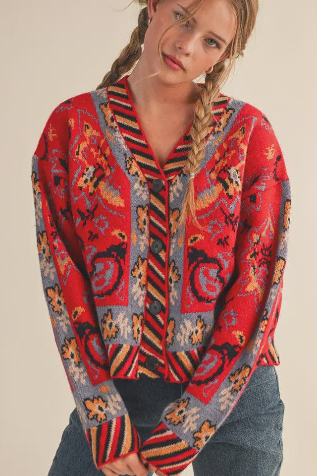 Woman wearing a colorful patterned shirt with a neutral background