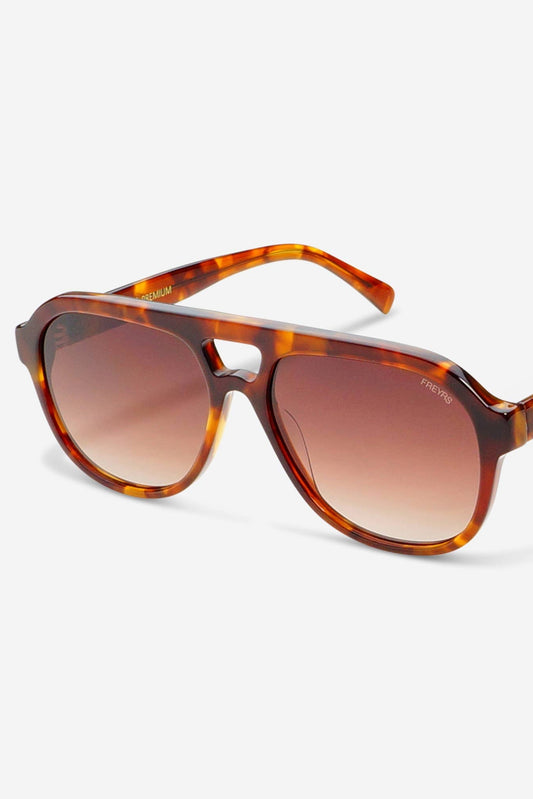 A pair of REVS Aviator sunglasses featuring a translucent brown and amber tortoiseshell frame with matching gradient brown lenses, shown on a clean white background.