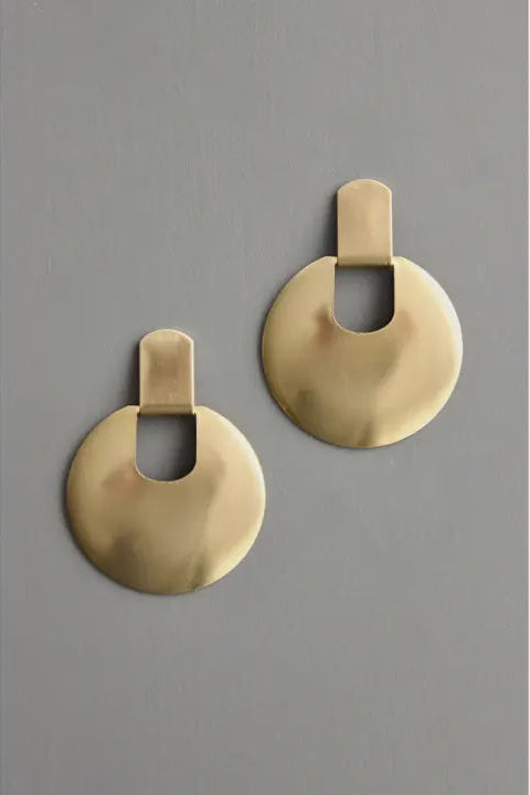 Pair of gold earrings on a gray background