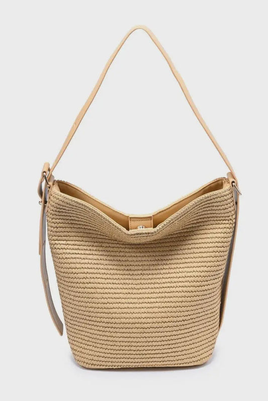 Beige woven handbag with a strap on a light gray background