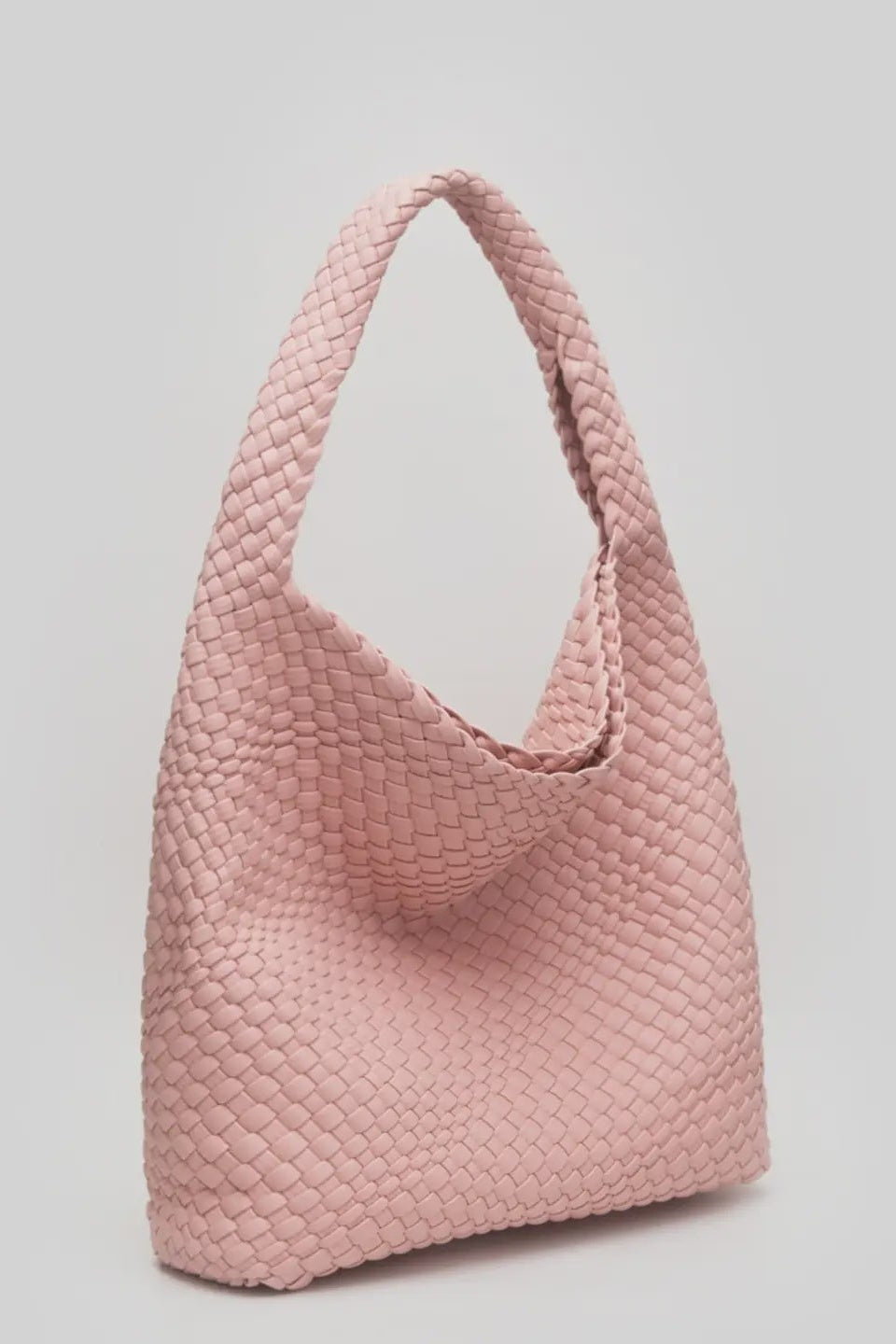 Pink woven handbag on a light gray background
