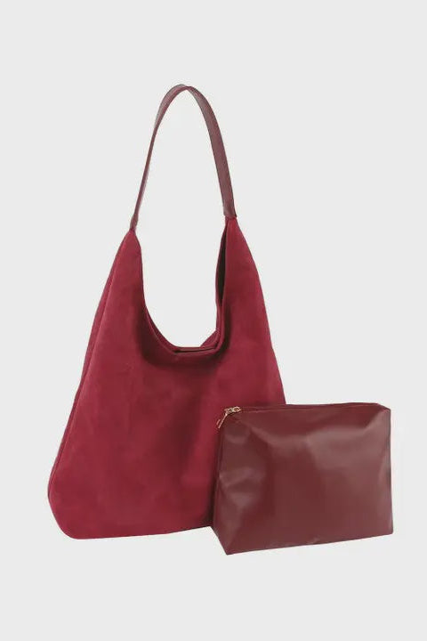 Red handbag and matching pouch on a light gray background