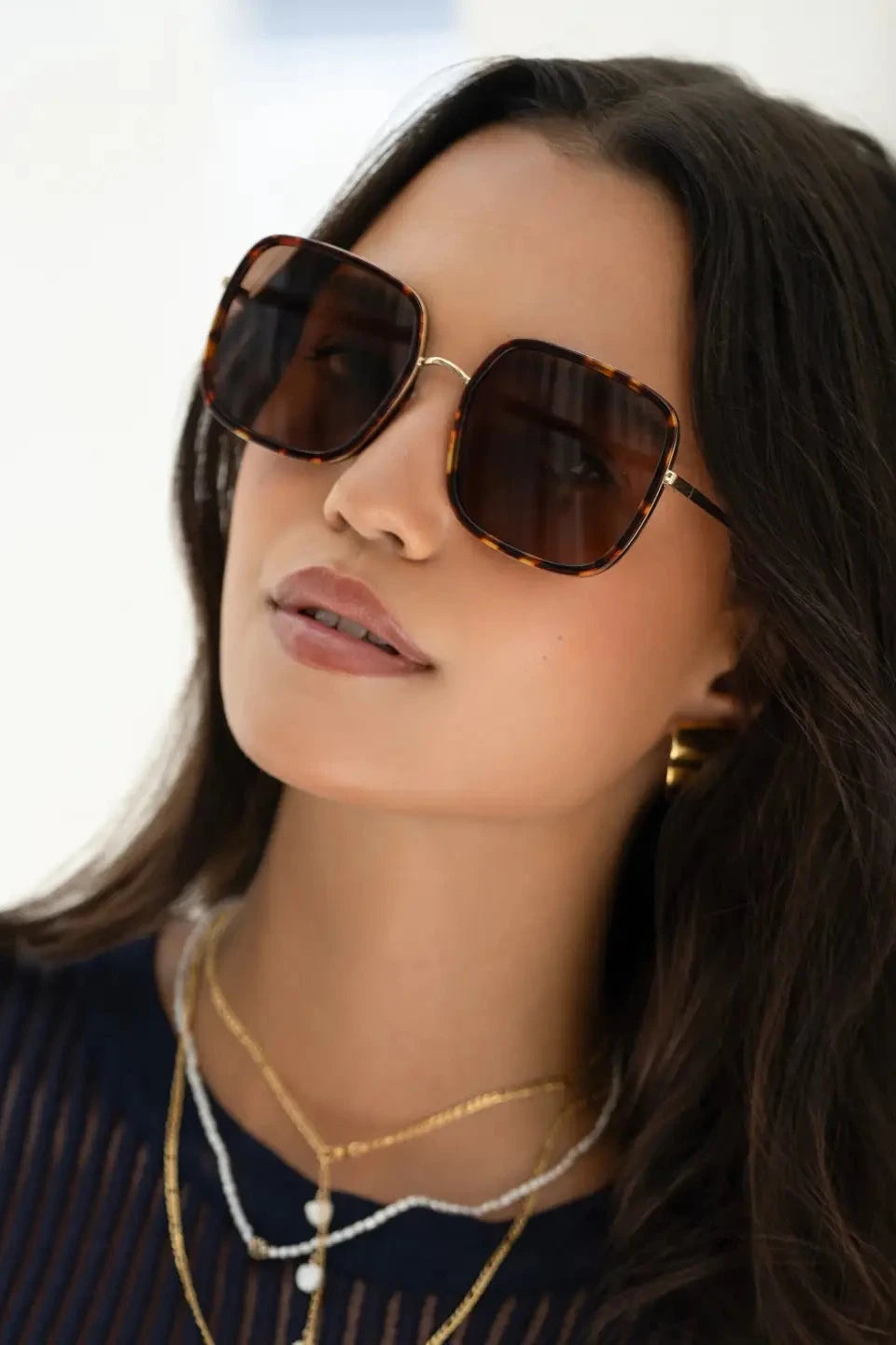 Woman wearing sunglasses with a blurred background