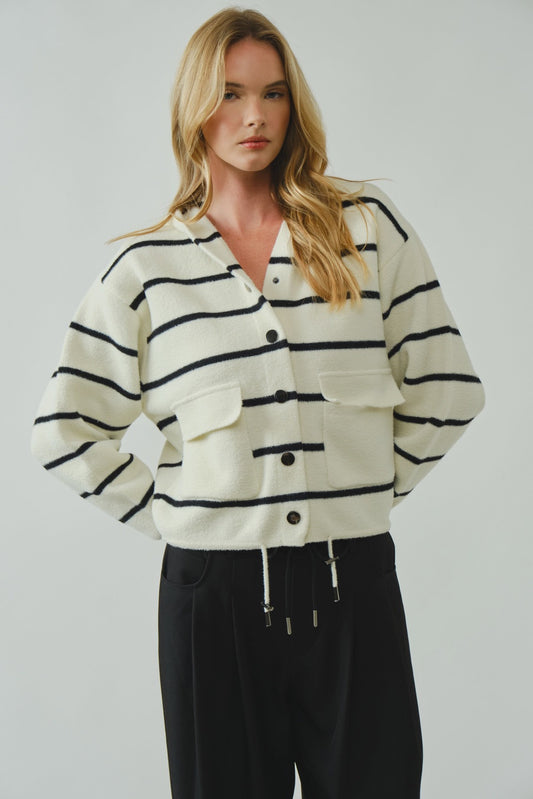 Woman wearing a black and white striped shirt with a plain background