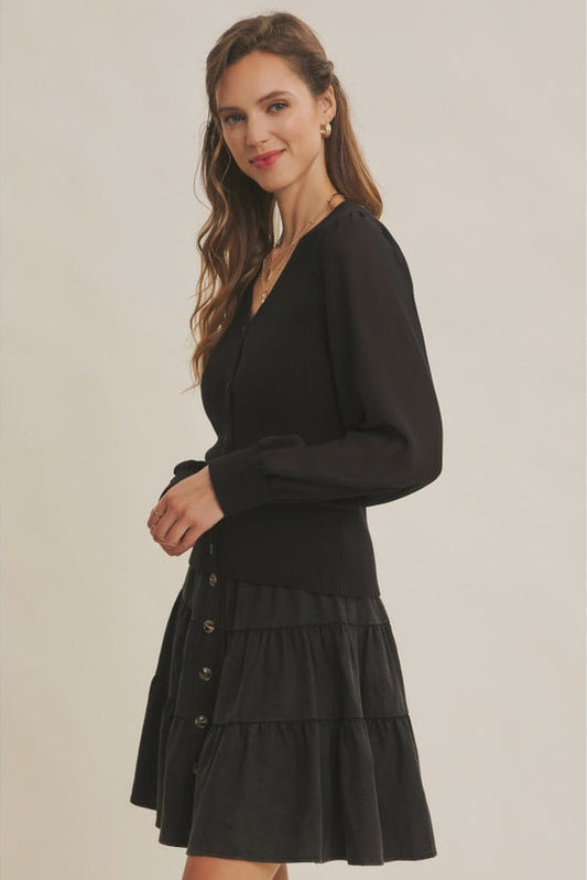 Woman wearing a black dress with a plain background