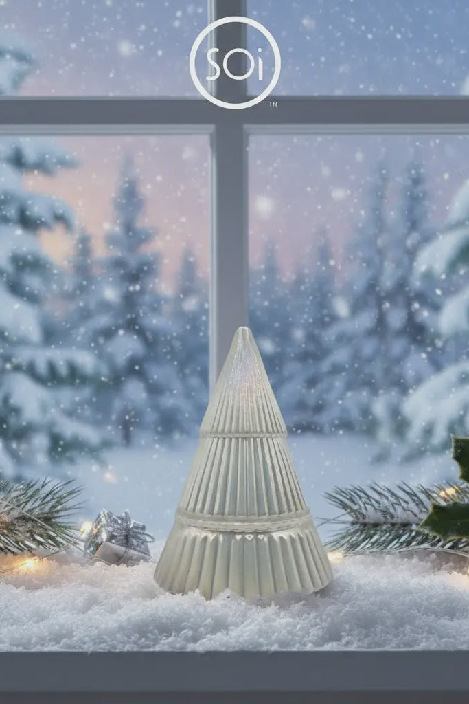 Decorative Christmas tree light on a snowy window sill with 'SOi' branding.