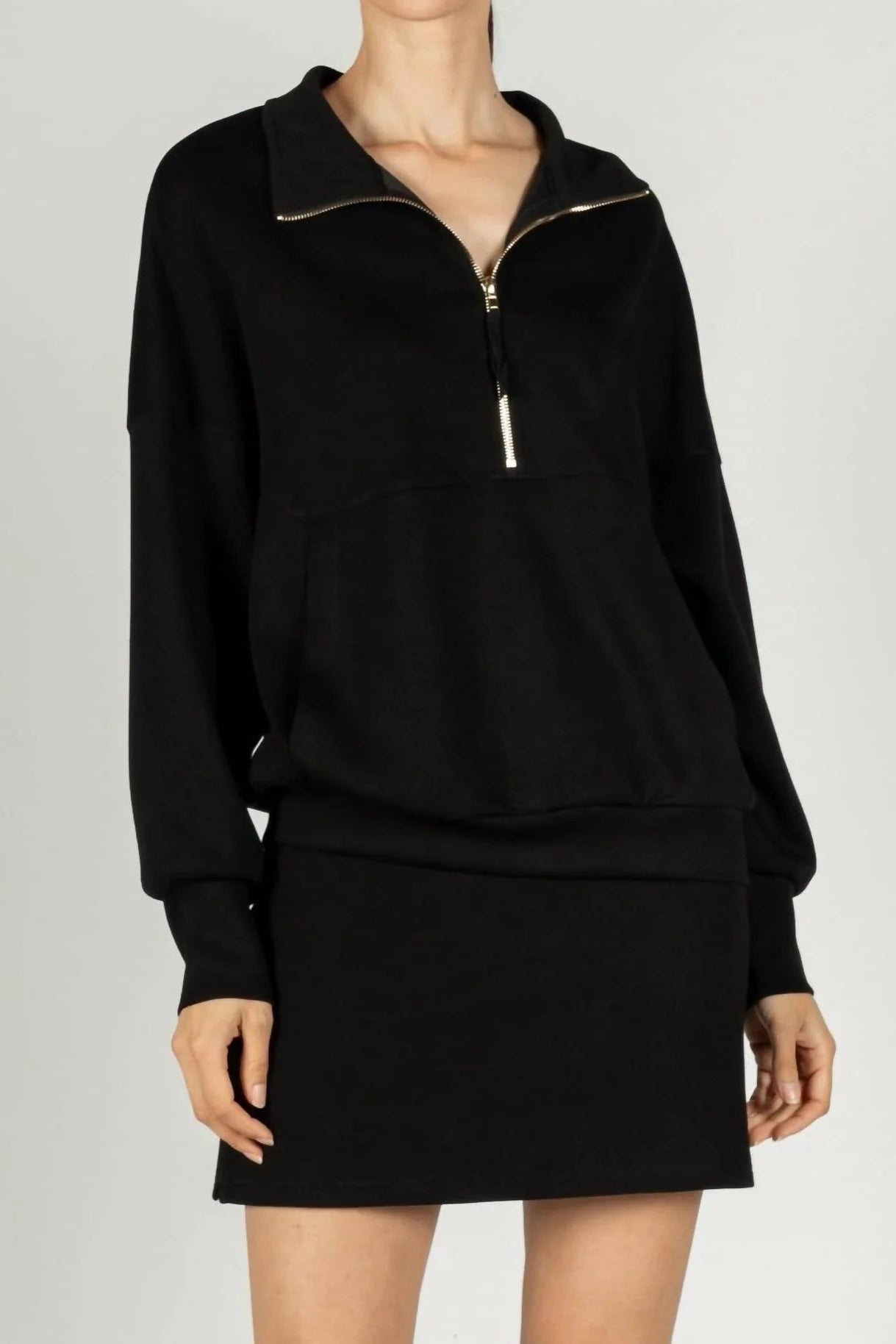Black zip-up sweatshirt and skirt set on a plain background