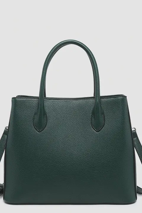 Green handbag with a shoulder strap on a light gray background
