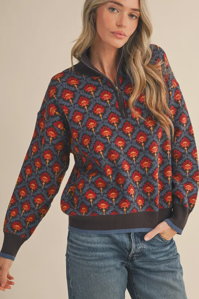 Woman wearing a patterned sweater with red and blue design on a beige background