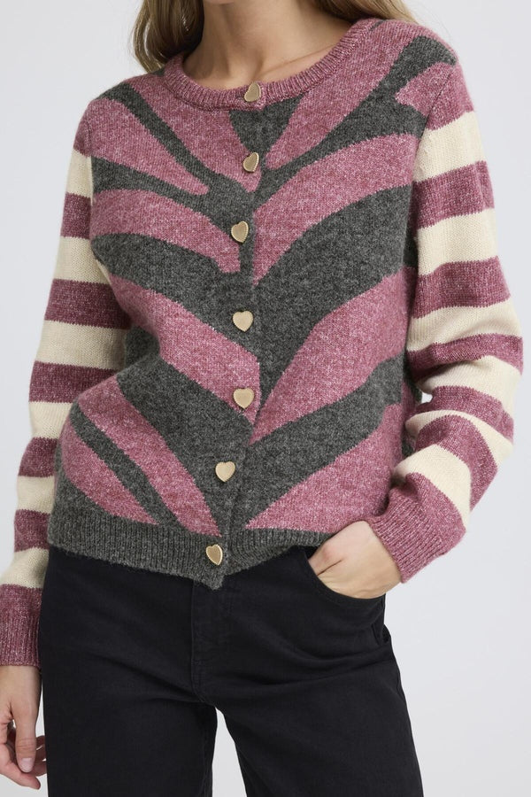 Person wearing a patterned sweater with vertical stripes on a white background