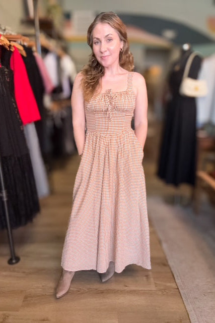 Woman wearing a patterned dress in a clothing store