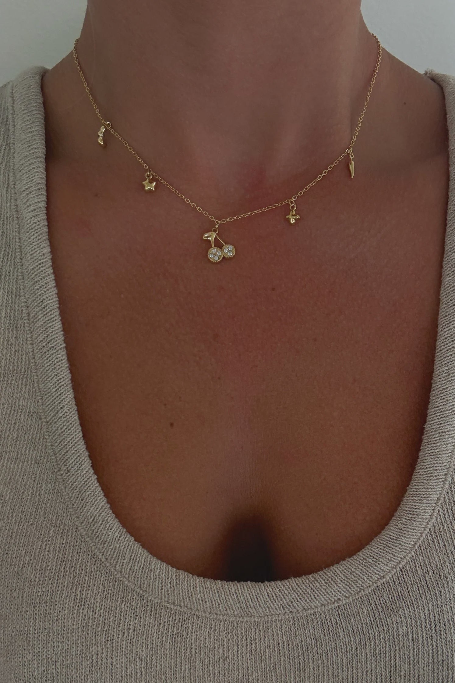 Necklace with small pendants on a plain background