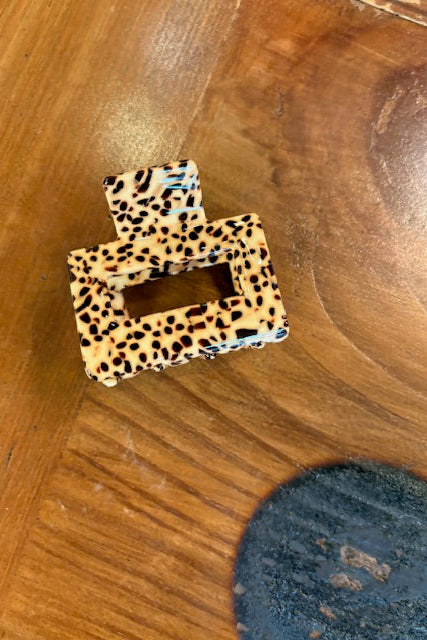 Leopard print letter 'D' on a wooden surface