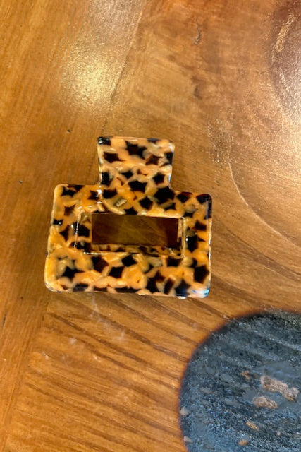 Leopard print square object on a wooden surface