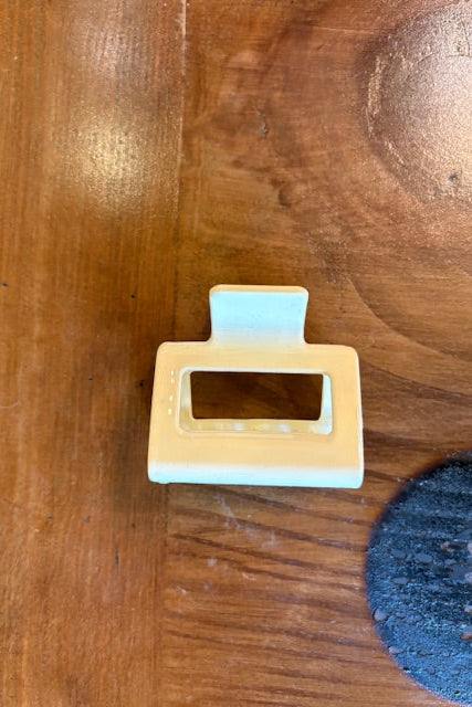 Beige plastic clip on a wooden surface