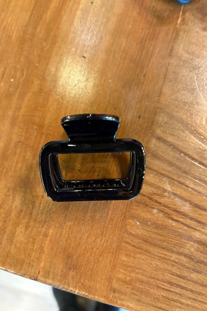 Black metal buckle on a wooden surface