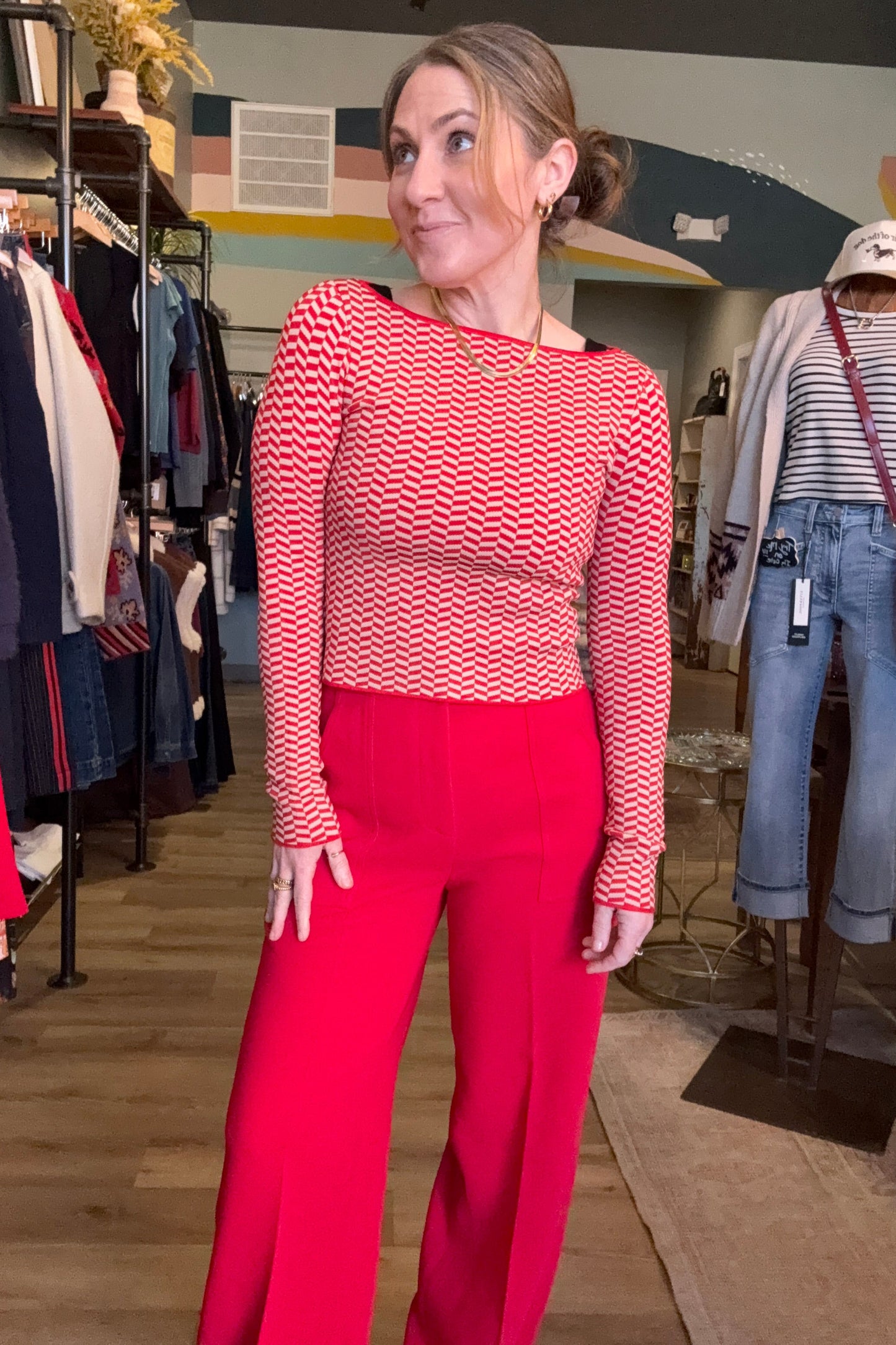 Person wearing a red and white checkered shirt and red pants in an indoor setting.