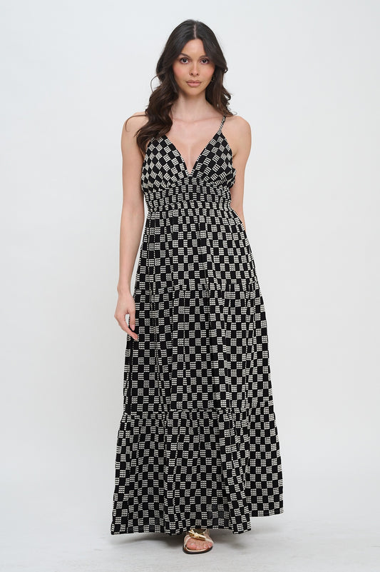 Woman wearing a black and white patterned dress on a white background