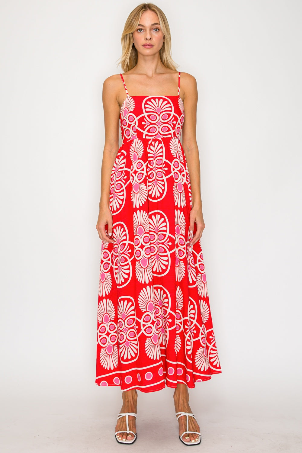 Woman wearing a red floral dress on a white background