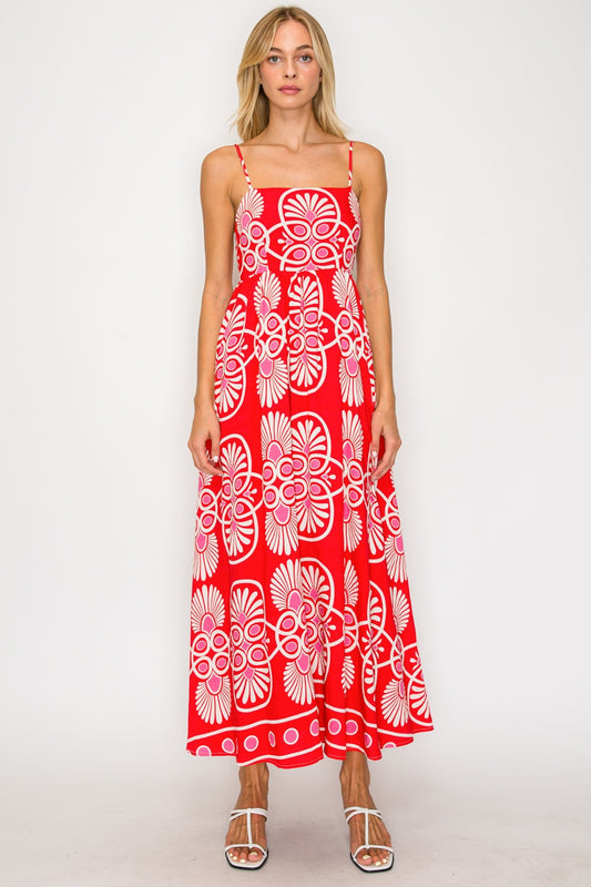 Woman wearing a red floral dress on a white background