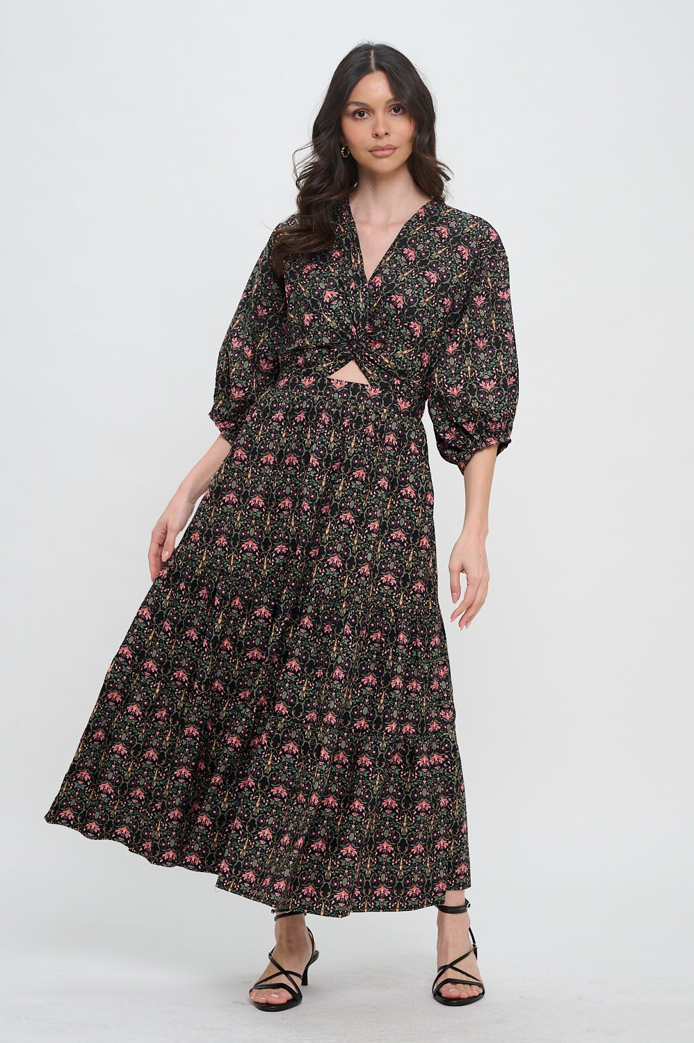 Woman wearing a black floral dress on a white background