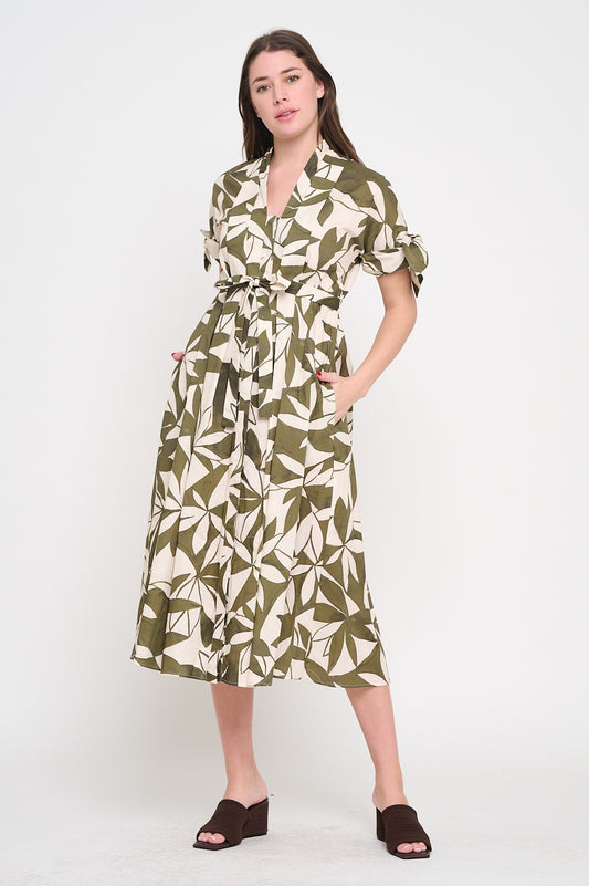 Woman wearing a green and white patterned dress on a white background