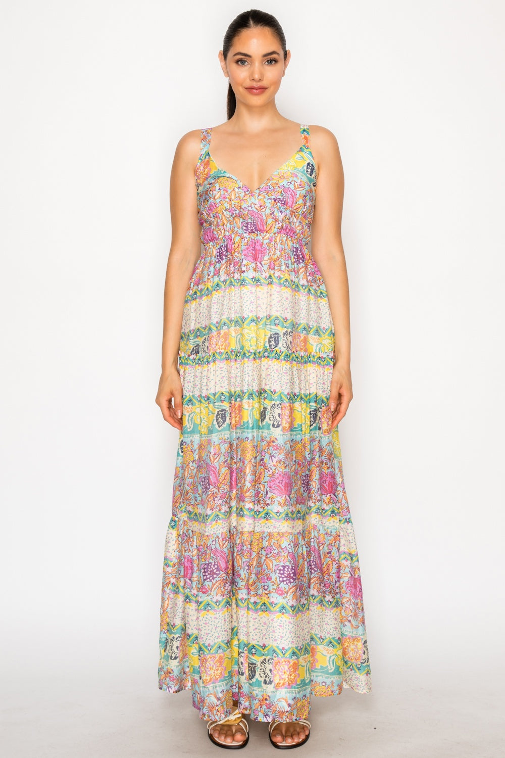 Woman wearing a colorful floral dress on a white background