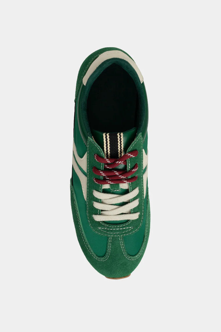 Green sneaker with white laces on a white background