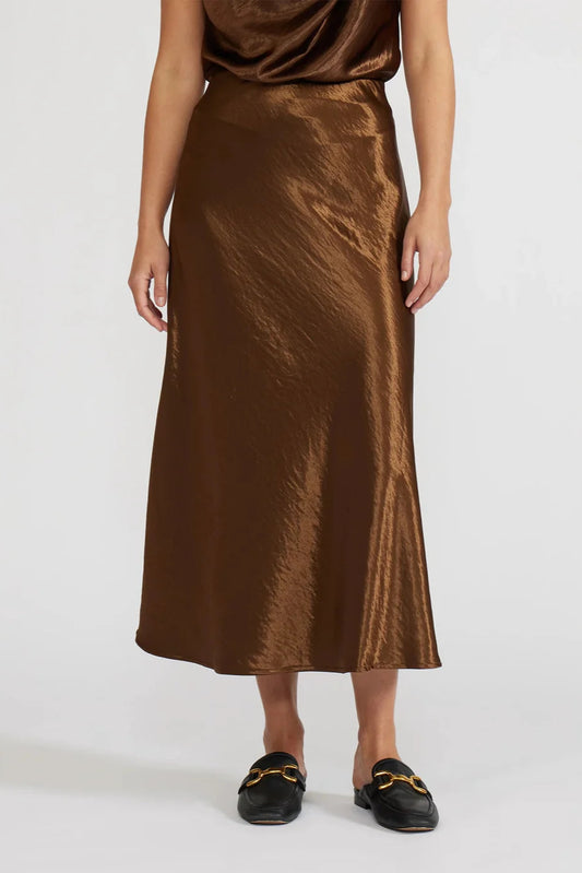 Brown satin skirt worn by a person on a white background