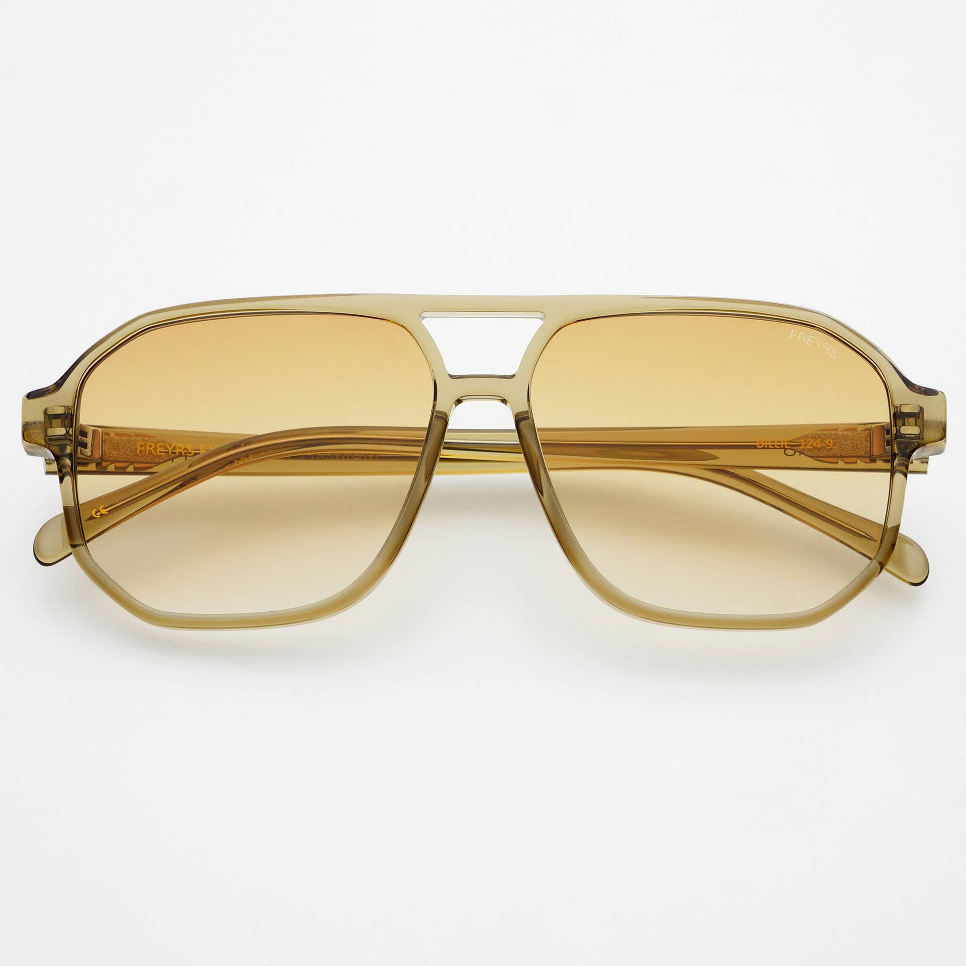 Gold-framed sunglasses with yellow-tinted lenses on a white background