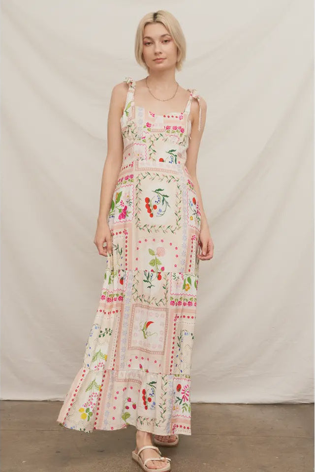 Woman wearing a floral patterned dress against a plain background