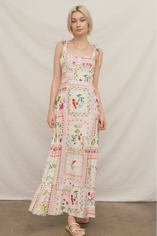 Woman wearing a floral patterned dress against a plain background