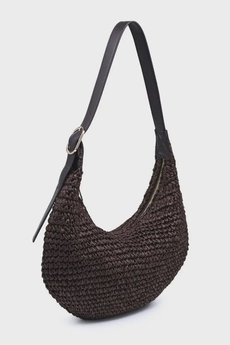 Brown woven handbag with a black strap on a light gray background