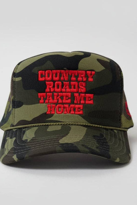 A camouflage trucker hat with red embroidered text reading 'COUNTRY ROADS TAKE ME HOME' on the front, shown against a light gray background.