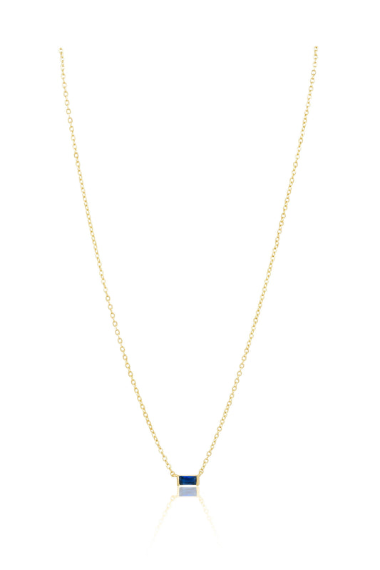 Gold necklace with a square pendant on a white background