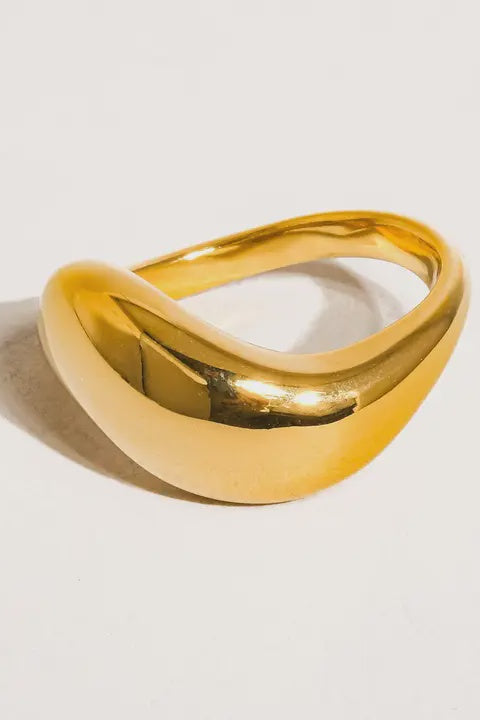 Gold ring on a light gray background
