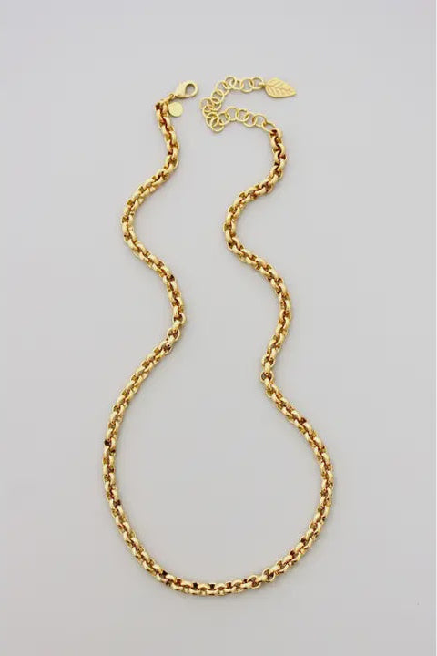 Gold chain necklace on a light gray background