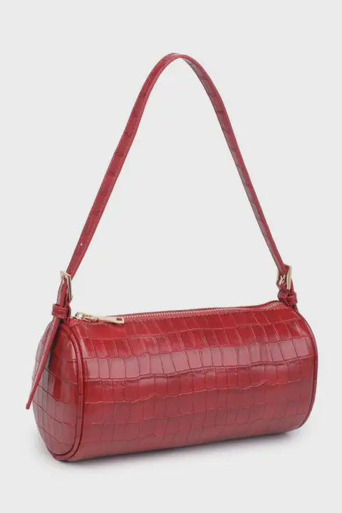 Red handbag with a textured pattern on a light gray background