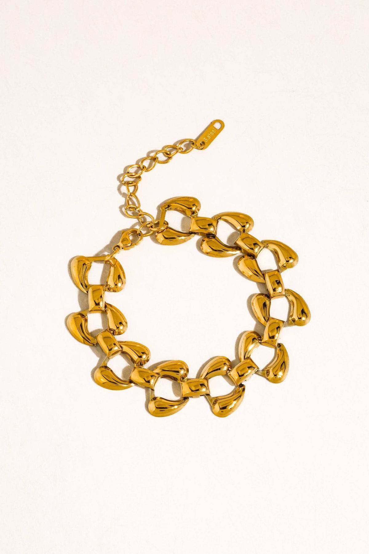 Gold chain bracelet on a white background