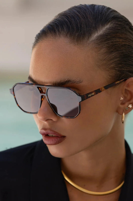 Woman wearing sunglasses with a blurred background