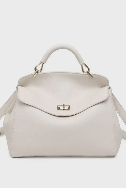 White handbag with gold accents on a light gray background