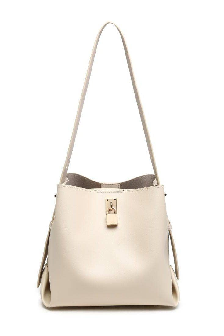 Beige handbag with a shoulder strap on a white background