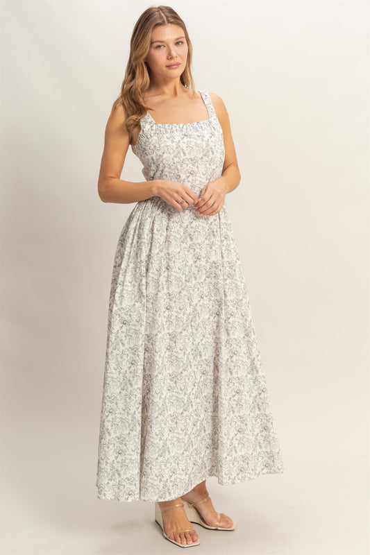 Woman wearing a floral dress on a plain background