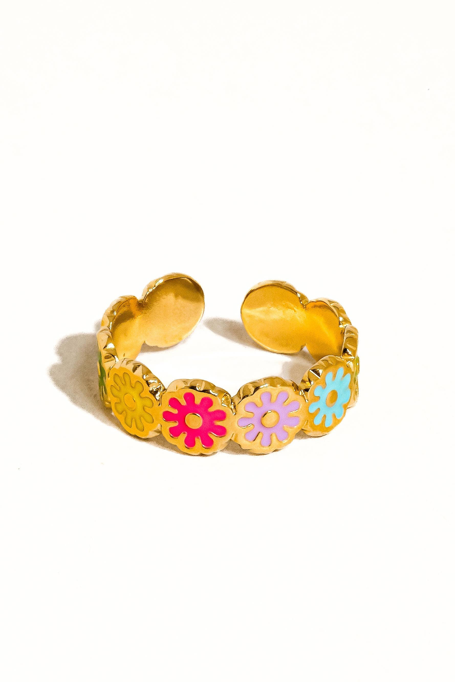 Gold ring with colorful flower-shaped charms on a white background
