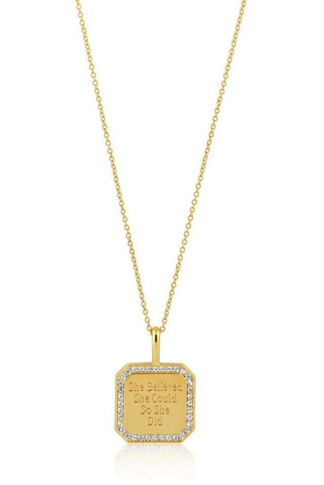 Gold necklace with a hexagonal pendant on a white background