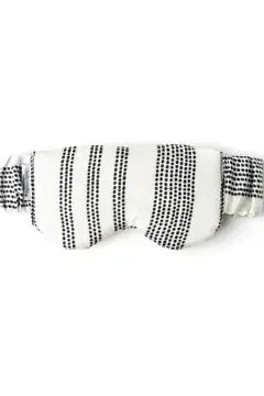 White eye mask with black pattern on a white background