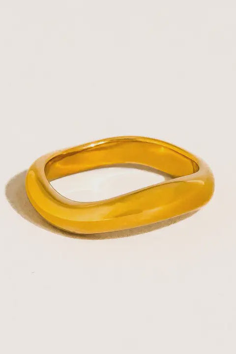 Gold ring on a light beige background